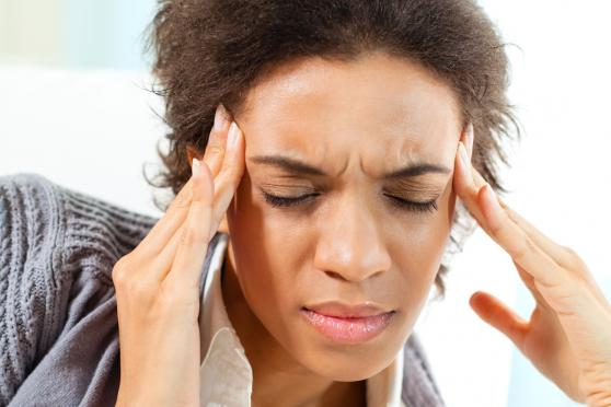 Photo: woman rubbing temples/forehead