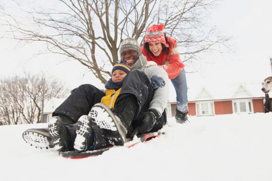 Photo: Happy family playing in the snow in winter