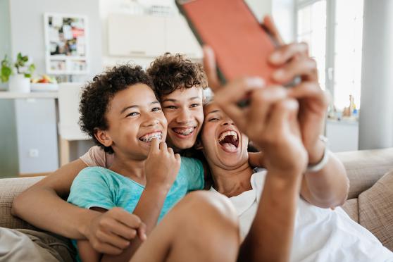 A mother shares a laugh with her two children.